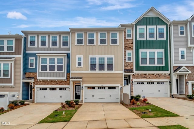 2735 Hunter Woods Dr # 571, Apex, NC 27502 - multi unit property with board and batten siding, stone siding, driveway, and an attached garage