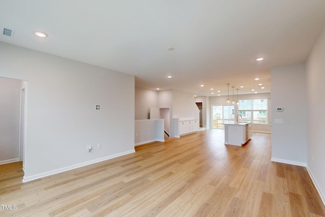 2735 Hunter Woods Dr # 571, Apex, NC 27502 - unfurnished living room featuring light wood-type flooring and recessed lighting