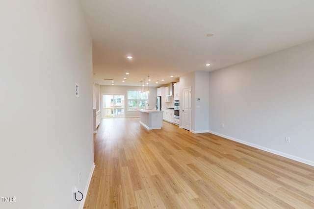 2735 Hunter Woods Dr # 571, Apex, NC 27502 - unfurnished living room featuring recessed lighting and light wood-style floors