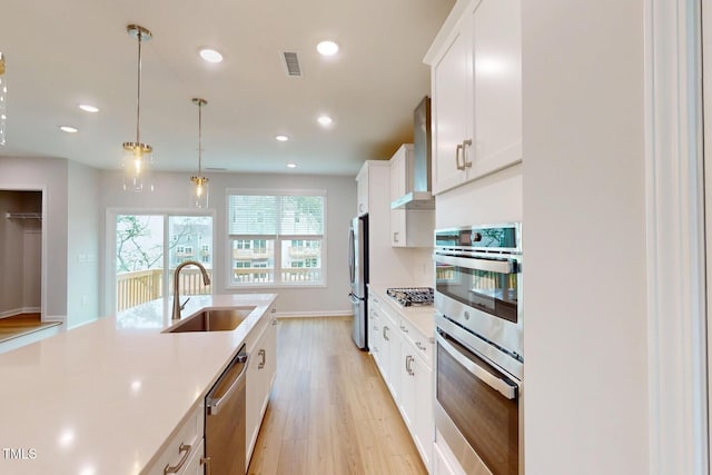 2735 Hunter Woods Dr # 571, Apex, NC 27502 - kitchen with appliances with stainless steel finishes, light countertops, light wood-type flooring, white cabinets, and recessed lighting