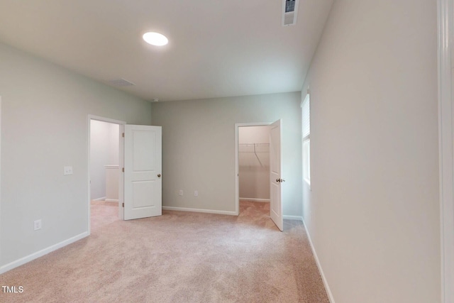 2735 Hunter Woods Dr # 571, Apex, NC 27502 - unfurnished bedroom with a spacious closet, light carpet, and a closet