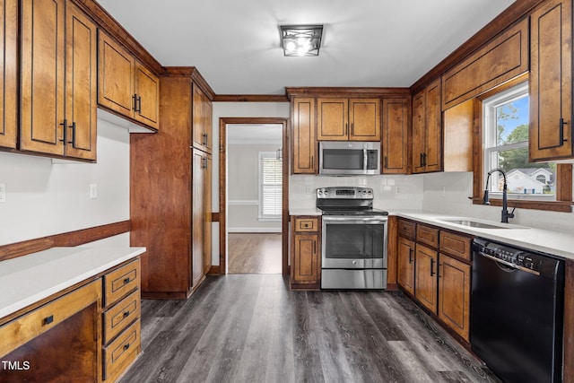 4408 Highmeadow Ln N, Wilson, NC 27896 - kitchen with appliances with stainless steel finishes, brown cabinets, dark wood finished floors, light countertops, and decorative backsplash