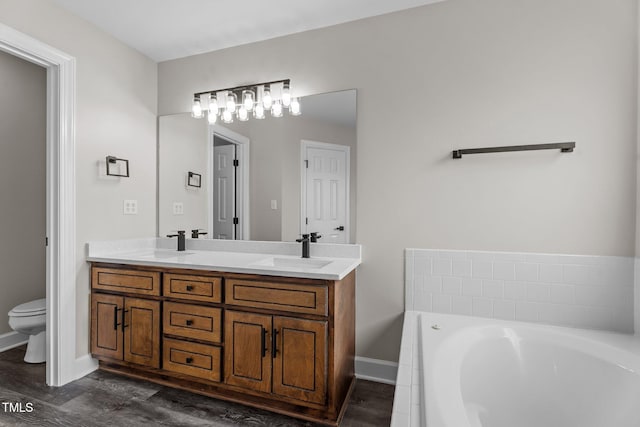 4408 Highmeadow Ln N, Wilson, NC 27896 - bathroom with double vanity, a garden tub, and wood finished floors