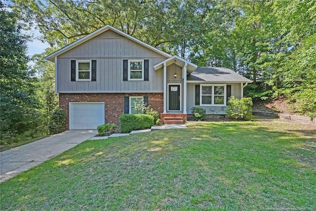 6405 Riegelwood St, Fayetteville, NC 28314 - split level home with an attached garage, concrete driveway, a front yard, and brick siding