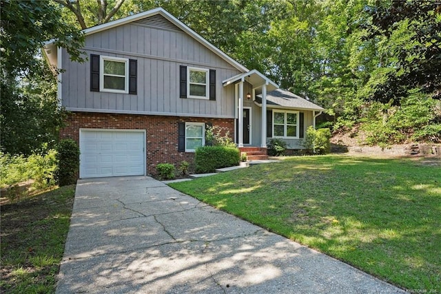 6405 Riegelwood St, Fayetteville, NC 28314 - tri-level home featuring an attached garage, a front yard, driveway, brick siding, and board and batten siding