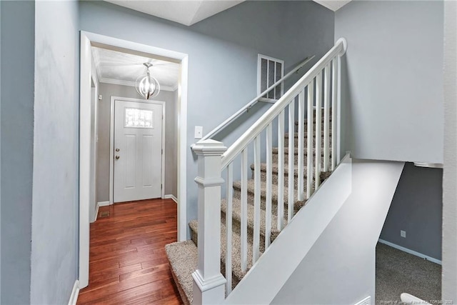 6405 Riegelwood St, Fayetteville, NC 28314 - staircase featuring a chandelier, ornamental molding, and wood finished floors