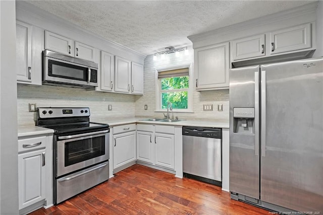6405 Riegelwood St, Fayetteville, NC 28314 - kitchen with stainless steel appliances, light countertops, white cabinetry, dark wood-style flooring, and a textured ceiling