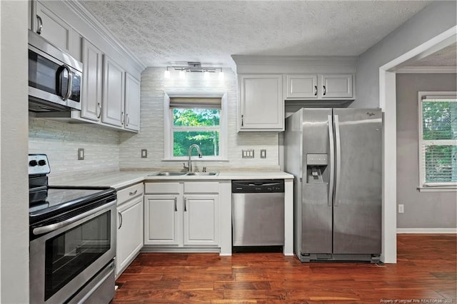 6405 Riegelwood St, Fayetteville, NC 28314 - kitchen featuring stainless steel appliances, light countertops, dark wood-style floors, decorative backsplash, and ornamental molding