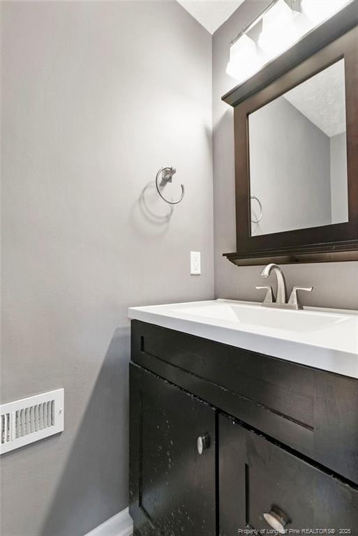 6405 Riegelwood St, Fayetteville, NC 28314 - bathroom with vanity and baseboards