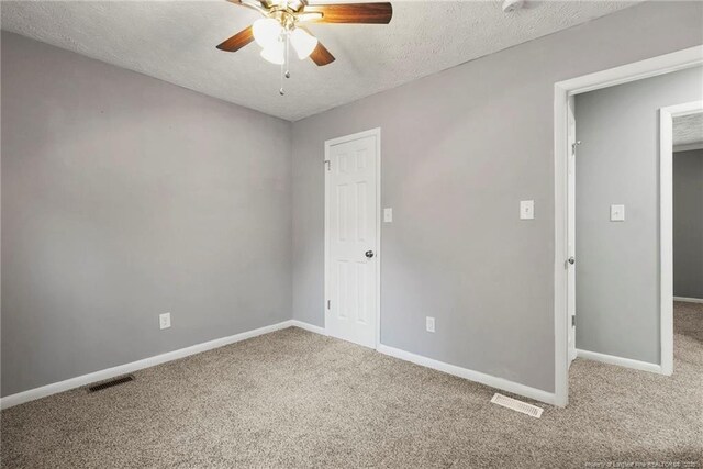 6405 Riegelwood St, Fayetteville, NC 28314 - unfurnished bedroom featuring carpet flooring, a textured ceiling, and a ceiling fan