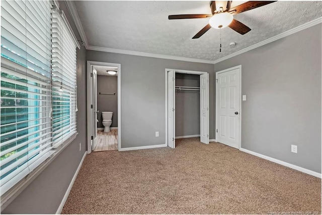 6405 Riegelwood St, Fayetteville, NC 28314 - unfurnished bedroom featuring carpet flooring, a textured ceiling, ensuite bath, a closet, and ornamental molding