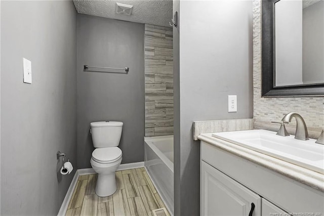 6405 Riegelwood St, Fayetteville, NC 28314 - bathroom with vanity, tasteful backsplash, a textured ceiling, and wood finished floors