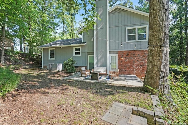 6405 Riegelwood St, Fayetteville, NC 28314 - back of property featuring a patio, a chimney, and brick siding