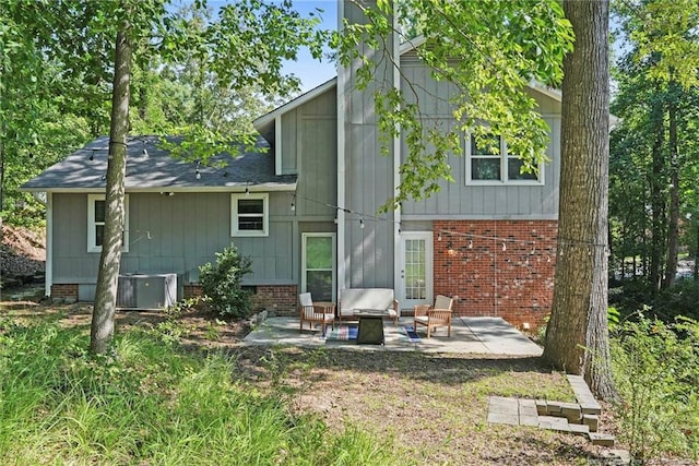 6405 Riegelwood St, Fayetteville, NC 28314 - back of house with a patio, brick siding, and roof with shingles