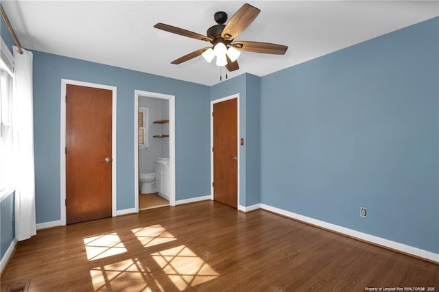 6411 Huntleigh Ct, Fayetteville, NC 28303 - unfurnished bedroom with wood finished floors, connected bathroom, and a ceiling fan