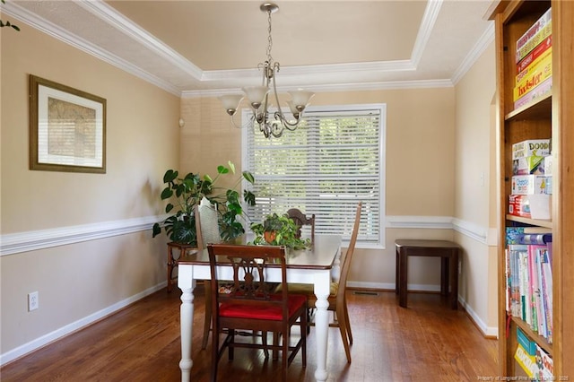 3401 Connection Dr, Fayetteville, NC 28311 - dining area with a chandelier, wood finished floors, crown molding, and a tray ceiling