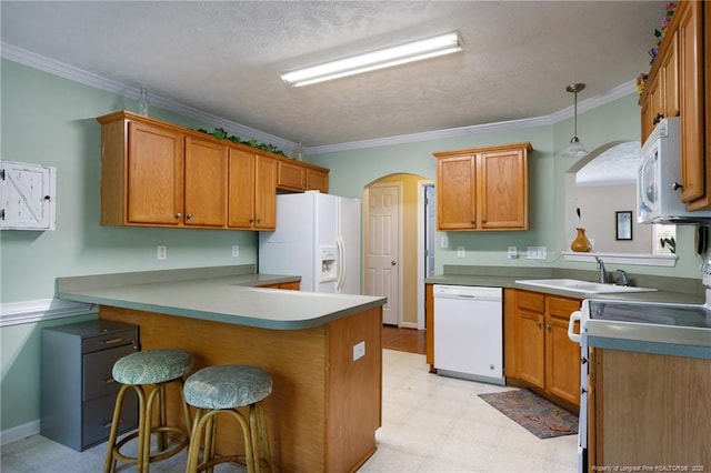 3401 Connection Dr, Fayetteville, NC 28311 - kitchen with white appliances, a peninsula, light floors, a kitchen bar, and crown molding