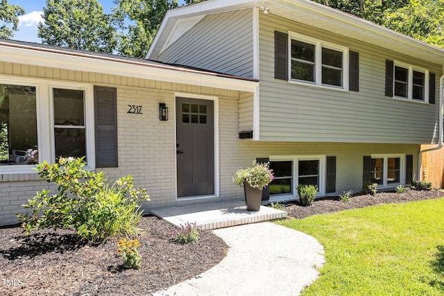2317 Bertie Dr, Raleigh, NC 27610 - view of front of home with brick siding and a front yard