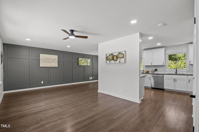 2317 Bertie Dr, Raleigh, NC 27610 - unfurnished living room with a ceiling fan, a decorative wall, recessed lighting, and dark wood finished floors