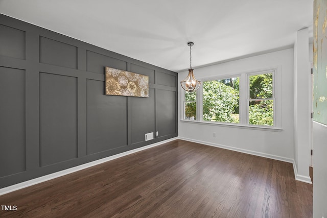 2317 Bertie Dr, Raleigh, NC 27610 - unfurnished dining area featuring a decorative wall, a chandelier, and dark wood-style flooring