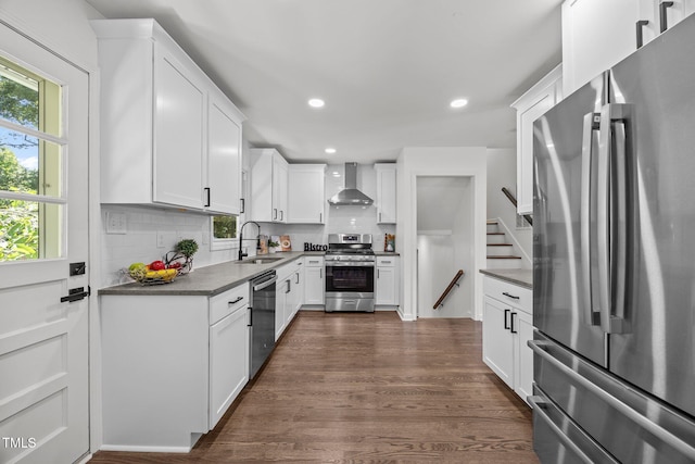 2317 Bertie Dr, Raleigh, NC 27610 - kitchen with stainless steel appliances, wall chimney range hood, recessed lighting, decorative backsplash, and dark wood-type flooring