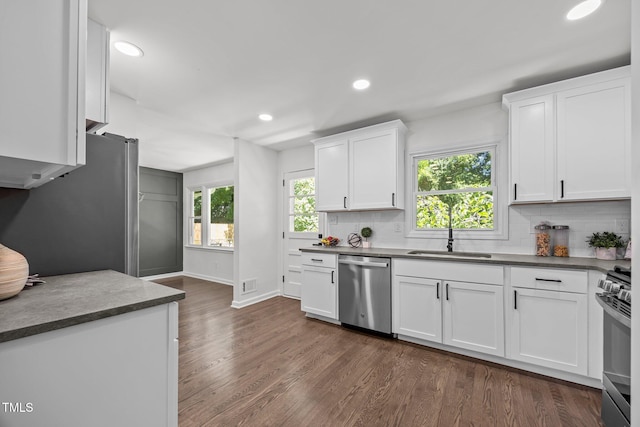 2317 Bertie Dr, Raleigh, NC 27610 - kitchen with stainless steel appliances, tasteful backsplash, dark countertops, dark wood-style floors, and recessed lighting