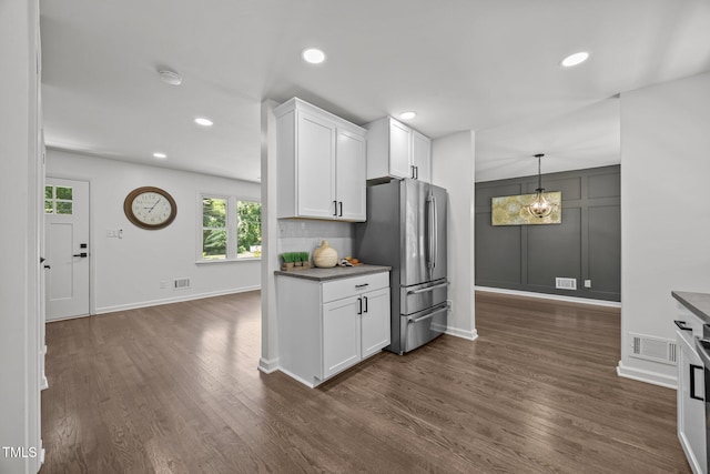 2317 Bertie Dr, Raleigh, NC 27610 - kitchen with freestanding refrigerator, dark wood-style flooring, white cabinetry, recessed lighting, and decorative light fixtures