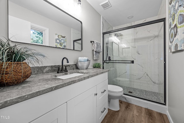 2317 Bertie Dr, Raleigh, NC 27610 - bathroom featuring wood finished floors, vanity, and a marble finish shower