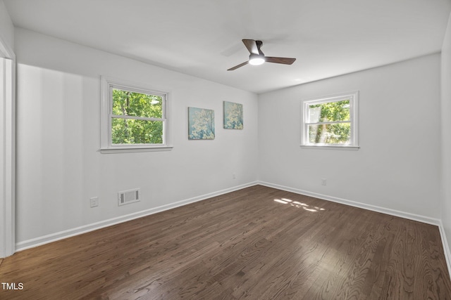2317 Bertie Dr, Raleigh, NC 27610 - unfurnished room featuring plenty of natural light, dark wood finished floors, and a ceiling fan