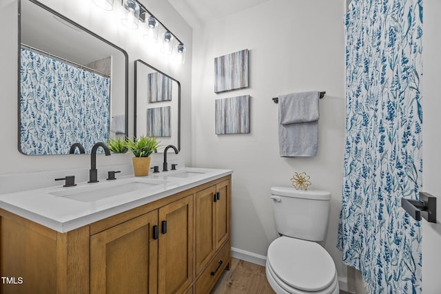 2317 Bertie Dr, Raleigh, NC 27610 - bathroom featuring double vanity, wood finished floors, and a shower with curtain