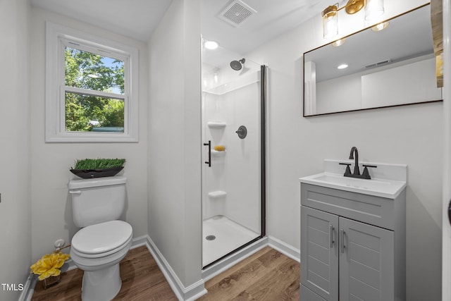 2317 Bertie Dr, Raleigh, NC 27610 - bathroom featuring wood finished floors, a stall shower, and vanity