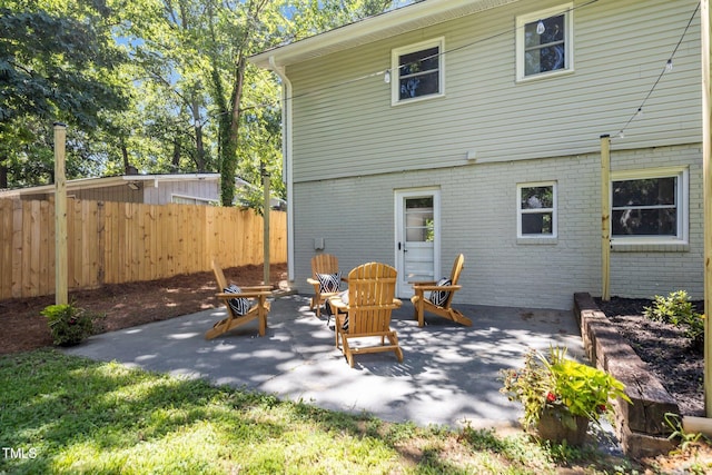 2317 Bertie Dr, Raleigh, NC 27610 - rear view of house with brick siding and a patio area