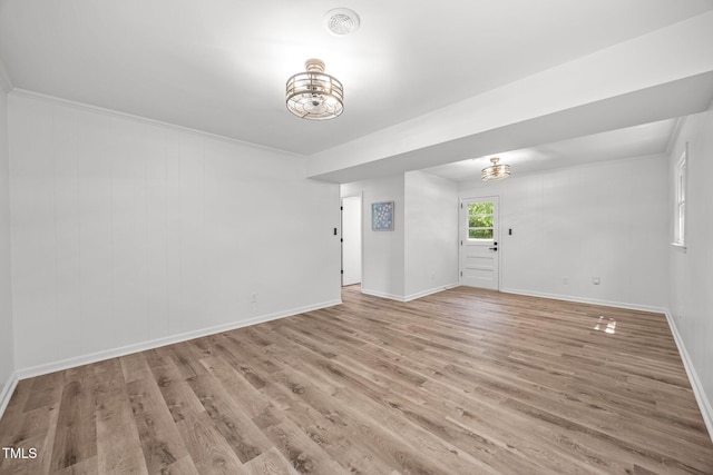2317 Bertie Dr, Raleigh, NC 27610 - spare room featuring a chandelier, wood finished floors, and ornamental molding