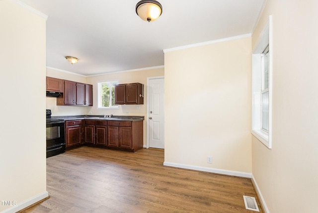 919 Chester St, Durham, NC 27701 - kitchen featuring black electric range, under cabinet range hood, ornamental molding, and light wood finished floors