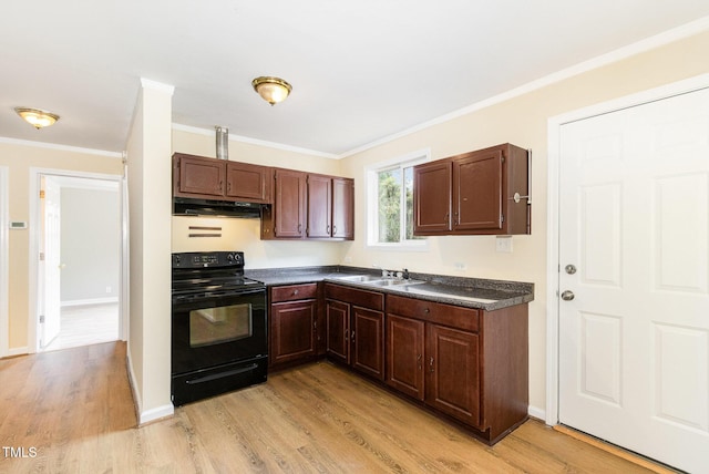 919 Chester St, Durham, NC 27701 - kitchen with black range with electric stovetop, under cabinet range hood, dark countertops, crown molding, and light wood-type flooring