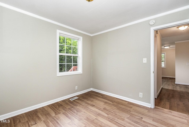 919 Chester St, Durham, NC 27701 - empty room with light wood-type flooring, a smoke detector, and ornamental molding