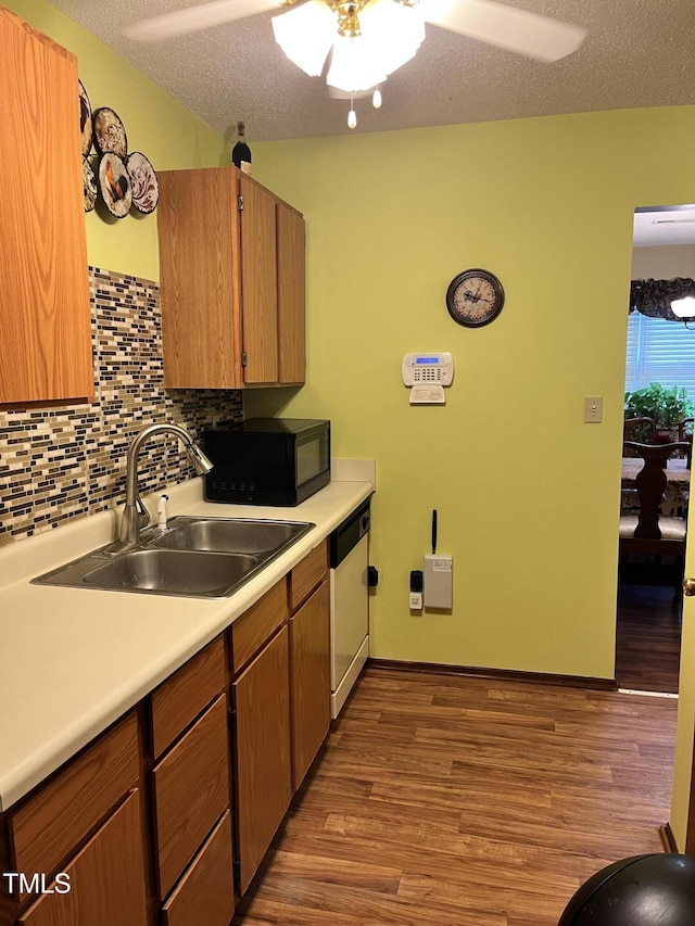 469 Whitehead Rd, Enfield, NC 27823 - kitchen featuring black microwave, dishwasher, ceiling fan, wood finished floors, and light countertops