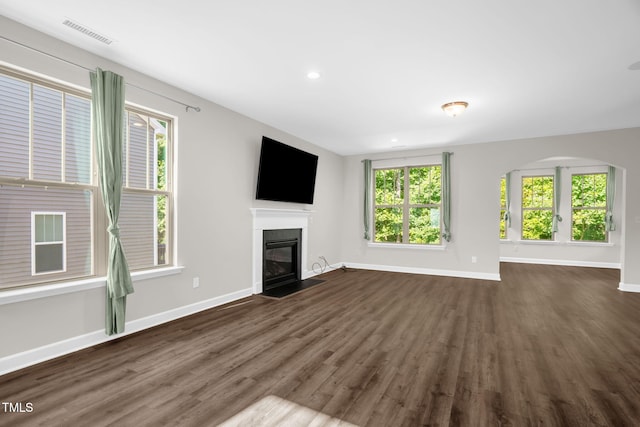 304 Garden Walk Dr, Durham, NC 27703 - unfurnished living room featuring a fireplace with flush hearth, dark wood finished floors, plenty of natural light, and recessed lighting