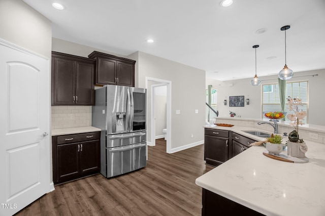 304 Garden Walk Dr, Durham, NC 27703 - kitchen with stainless steel refrigerator with ice dispenser, dark brown cabinets, backsplash, dark wood-style floors, and recessed lighting