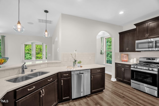 304 Garden Walk Dr, Durham, NC 27703 - kitchen with appliances with stainless steel finishes, arched walkways, healthy amount of natural light, wood finished floors, and recessed lighting