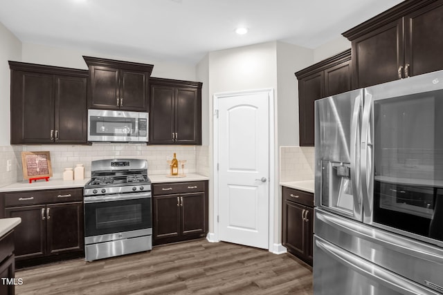 304 Garden Walk Dr, Durham, NC 27703 - kitchen with stainless steel appliances, dark wood-style flooring, light countertops, backsplash, and recessed lighting