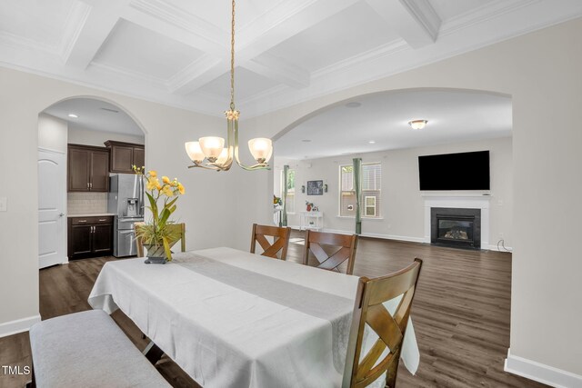 304 Garden Walk Dr, Durham, NC 27703 - dining area with a chandelier, coffered ceiling, dark wood-type flooring, beam ceiling, and a glass covered fireplace