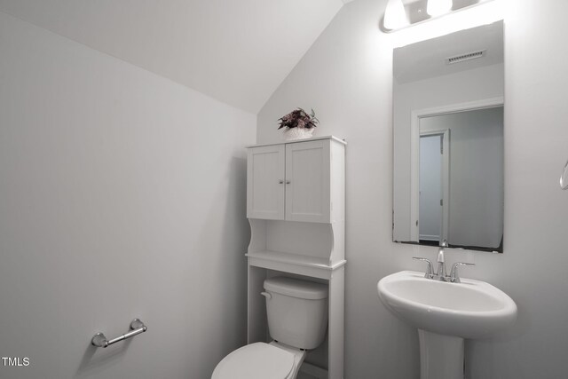 304 Garden Walk Dr, Durham, NC 27703 - bathroom featuring toilet and lofted ceiling