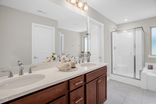 304 Garden Walk Dr, Durham, NC 27703 - bathroom featuring a shower stall, double vanity, a bath, and plenty of natural light