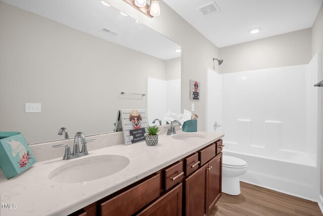 304 Garden Walk Dr, Durham, NC 27703 - bathroom featuring double vanity, shower / bathtub combination, and wood finished floors