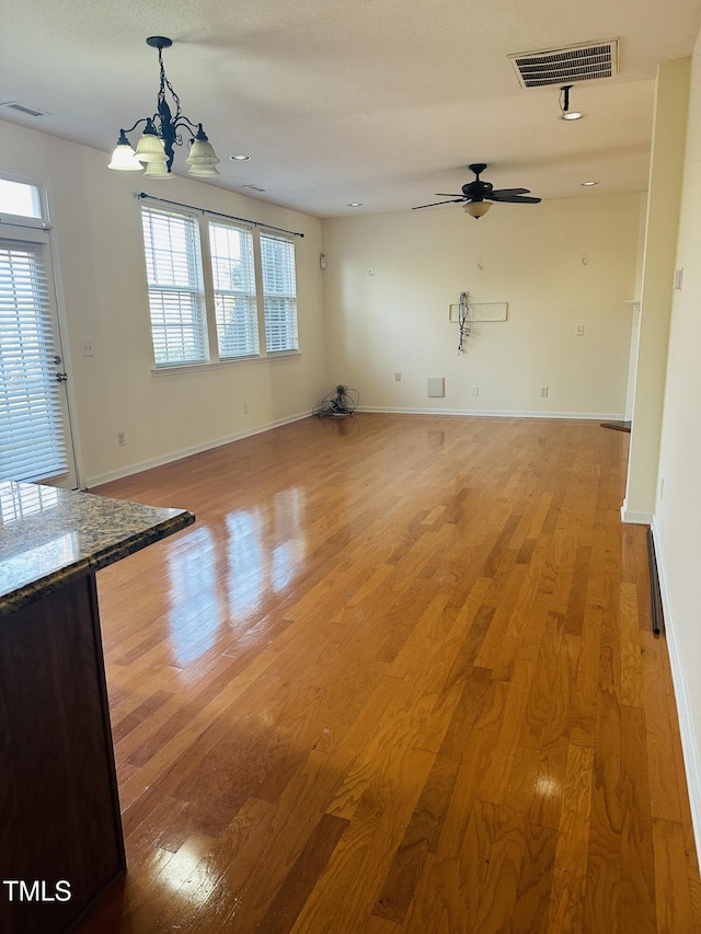 1150 Brookhill Way, Cary, NC 27519 - unfurnished living room featuring light wood-style floors, a ceiling fan, and a chandelier