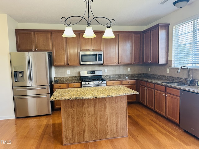 1150 Brookhill Way, Cary, NC 27519 - kitchen with appliances with stainless steel finishes, wood finished floors, a center island, and dark stone counters