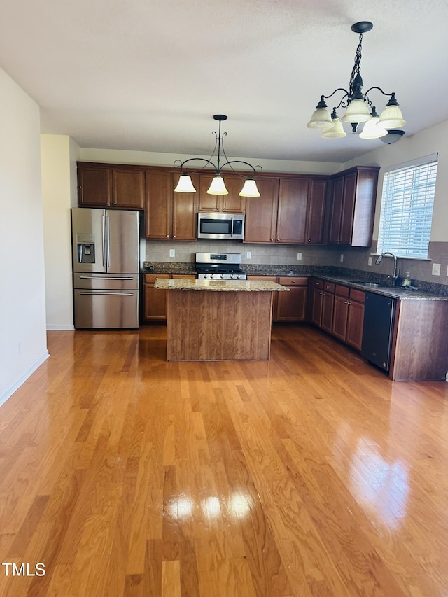 1150 Brookhill Way, Cary, NC 27519 - kitchen with stainless steel appliances, a chandelier, light wood-type flooring, and decorative light fixtures