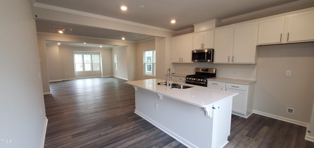 1426 Rosepine Dr, Cary, NC 27519 - kitchen with appliances with stainless steel finishes, crown molding, dark wood-style flooring, a kitchen island with sink, and white cabinets