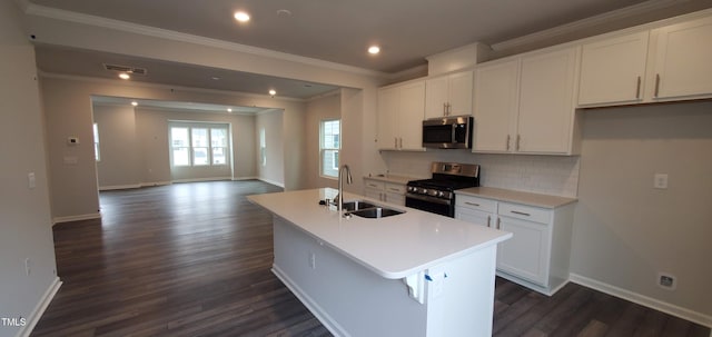 1426 Rosepine Dr, Cary, NC 27519 - kitchen with appliances with stainless steel finishes, white cabinets, dark wood-type flooring, ornamental molding, and a center island with sink